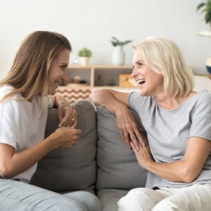 Two women chatting on a couch
