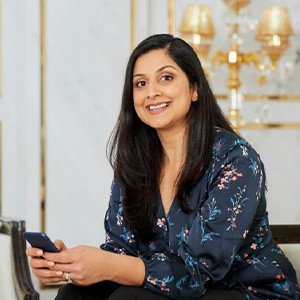 Smiling woman in a blue floral blouse