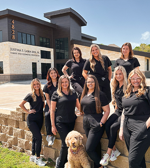 Dr. Laska and team having group picture taken outside of Fort Worth dental office