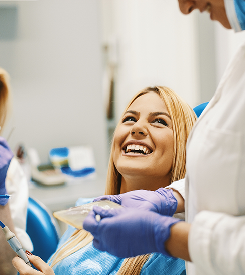 Blonde haired woman looking up and smiling