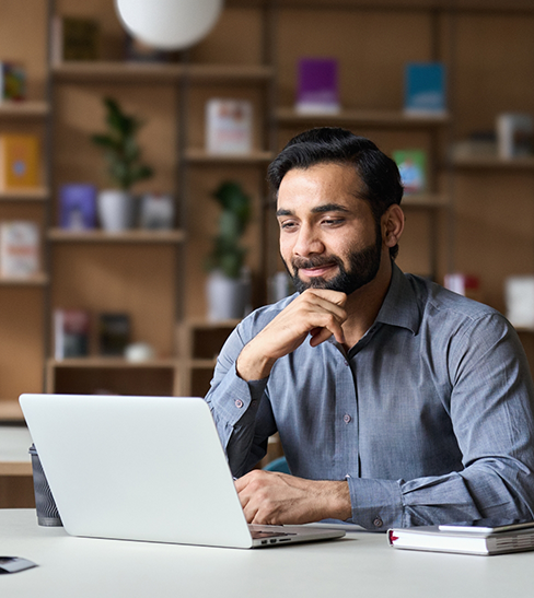 Man with beard and mustache working on computer