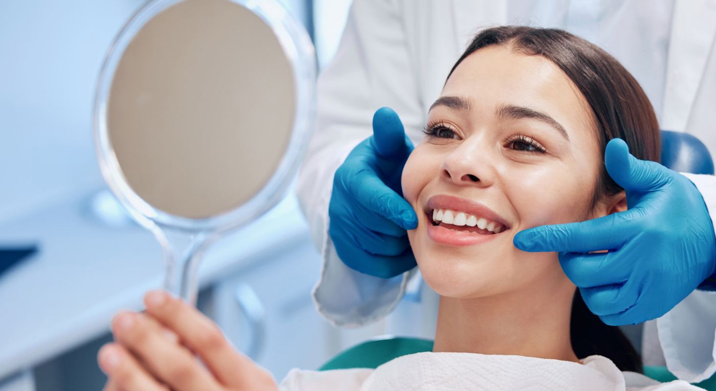 Dentist pulling back patient's lips to show them their teeth