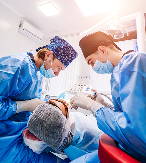 Two dentists performing a wisdom tooth extraction in Fort Worth